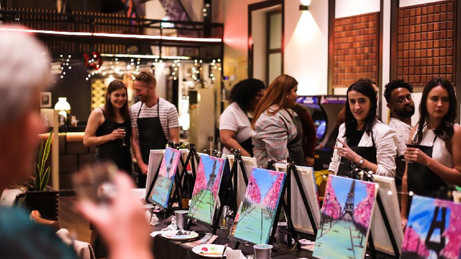 Social Painting with a twist - paint brush in one hand and a glass in another! 